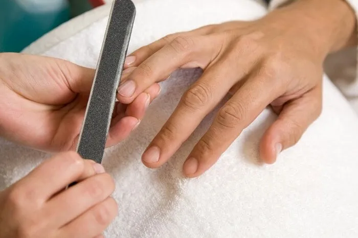 closeup of man's hands having manicure in salon 